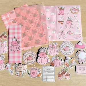 May include: A collection of pink-themed stationery items including a bookmark, several sheets of patterned paper, and various die-cut stickers featuring pumpkins, acorns, candles, and floral motifs with text reading Sweet Pumpkin Season.