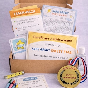 May include: A cardboard box filled with educational materials. Includes a certificate, word search, medal, crayons, and a measuring tape. The box contains cards with text about staying safe and social distancing.