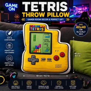 May include: A yellow Tetris throw pillow shaped like a handheld gaming console. The pillow features a screen displaying a game in progress, a directional pad, A and B buttons, and the text Tetris. It measures 15.7 by 15.7 inches in total size.