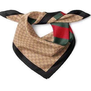 May include: A square silk scarf featuring a beige background with a repeating brown circular pattern. The scarf includes a wide black border and a prominent section with alternating horizontal red and dark green stripes across the fabric surface.