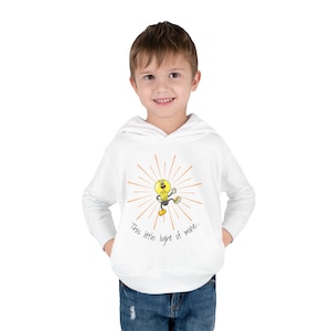 May include: White hooded sweatshirt featuring a cartoon lightbulb character with radiating lines and the text "This little light of mine." The lightbulb is yellow with black details and is wearing yellow shoes.