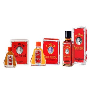 May include: Several bottles of Siang Pure Oil are displayed, each with a red label and a portrait of a man. The bottles vary in shape and size, with orange and black caps. The packaging includes text in multiple languages.