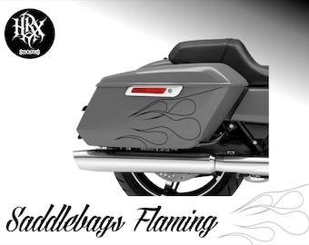 May include: A gray motorcycle saddlebag featuring a black flame decal design. The saddlebag includes a horizontal red reflector light and is positioned above a chrome exhaust pipe and a black motorcycle wheel. The text HRX STICKERS appears.