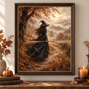 Könnte beinhalten: Ein gerahmter Kunstdruck, der eine Figur in einem schwarzen Kleid und einem spitzen Hut zeigt, die einen Pfad durch einen herbstlichen Wald entlanggeht. Die Szene enthält orangefarbene Ahornblätter, einen Besen und eine neblige Landschaft.