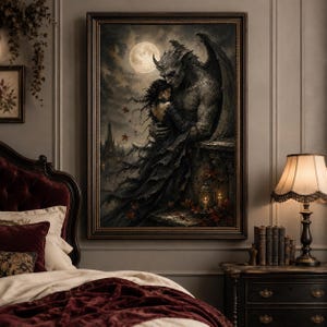 May include: A framed gothic art print depicts a winged gargoyle embracing a woman under a full moon. The artwork features dark tones, a castle silhouette, and autumn leaves, creating a romantic, yet eerie atmosphere. The print is displayed above a bed with a burgundy headboard.