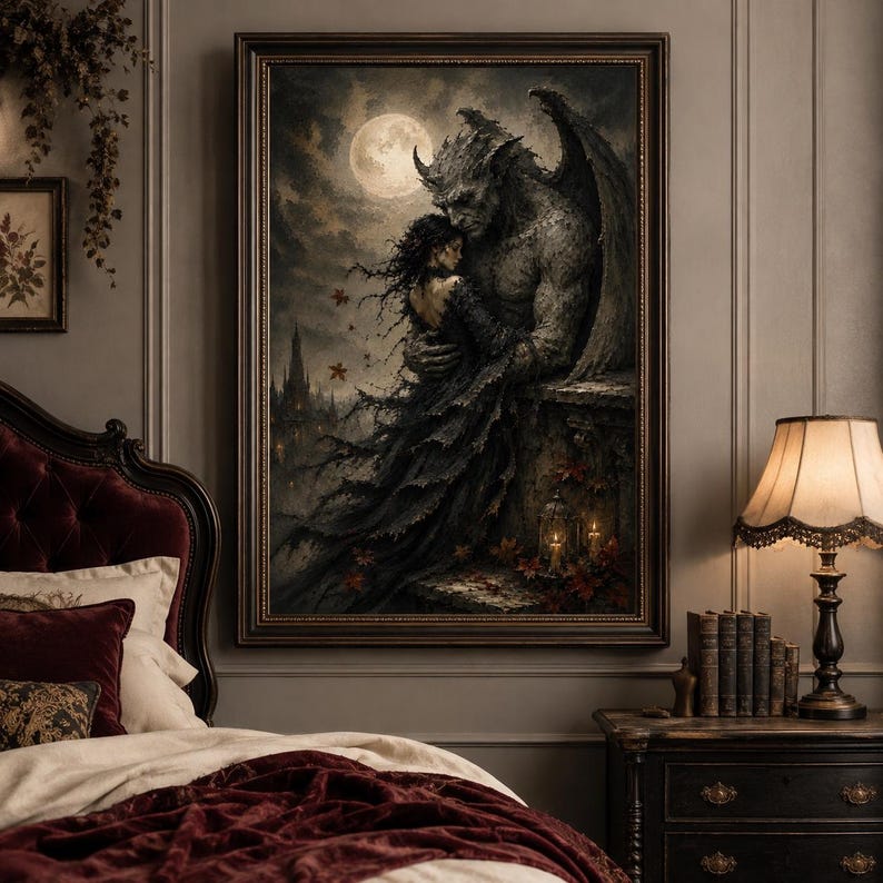 May include: A framed gothic art print depicts a winged gargoyle embracing a woman under a full moon. The artwork features dark tones, a castle silhouette, and autumn leaves, creating a romantic, yet eerie atmosphere. The print is displayed above a bed with a burgundy headboard.