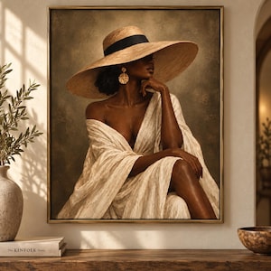 May include: A framed wall art print depicting a person with dark skin wearing a wide-brimmed straw hat with a black band and a textured cream-colored wrap dress. The person wears a large gold circular earring and is posed with one hand near the chin.