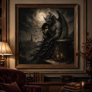 May include: A framed painting depicts a dark fantasy scene. A winged demon embraces a woman under a full moon. The artwork is in shades of gray, black, and white, with a gothic castle in the background. The frame is gold.