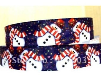 May include: Blue ribbon with a repeating pattern of snowmen wearing red and white striped scarves. The snowmen are on a dark blue background with white and red confetti.