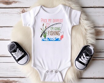 Könnte beinhalten: Ein weißer kurzärmeliger Babybody mit dem Text Pack My Diapers! I'm Going Fishing in Pink, Grün und Braun. Die Grafik zeigt eine Angelrute, Rohrkolben, ein kleines rosa Herz und einen roten Fisch, der aus blauem Wasser springt.