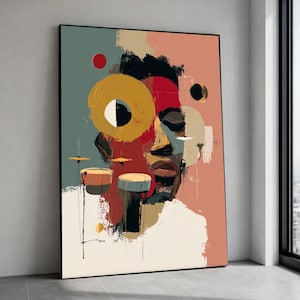 May include: Abstract art print featuring a stylized portrait with a face composed of geometric shapes and bold colors. The artwork includes a large yellow circle, red accents, and drum-like shapes. The background has a mix of teal, peach, and beige tones.