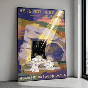 May include: A framed religious art print with the text "HE IS NOT HERE HE IS RISEN". The artwork depicts an open tomb with a large stone, rays of light, and white cloth. The color palette includes purple, gold, and blue.