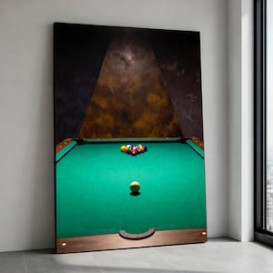 May include: A large framed print of a pool table. The green felt table has a rack of billiard balls at one end and the cue ball at the other. The background is a dark, textured abstract design.
