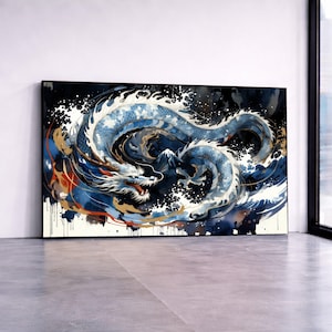 May include: A framed watercolor painting of a blue and white dragon in a swirling sea. The dragon is depicted with intricate details, set against a dark background with splashes of gold and white. The artwork is displayed on a white wall.