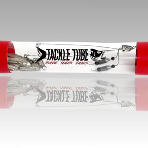 May include: A clear plastic Tackle Tube with red end caps, containing fishing lures. The tube has black text that reads "TACKLE TUBE" and "SAVE YOUR TAILS". The lures are silver and black.