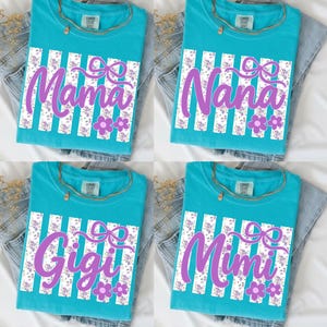 May include: Four turquoise t-shirts with different names printed in purple script: "Mama", "Nana", "Gigi", and "Mimi". Each shirt features a white striped design with floral accents and a bow. The shirts are folded on top of denim.