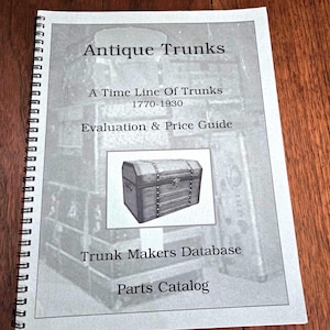 May include: A spiral-bound reference book titled Antique Trunks: A Time Line Of Trunks 1770-1930 Evaluation & Price Guide, Trunk Makers Database, Parts Catalog. The cover features a black and white photograph of a wooden trunk with metal hardware.
