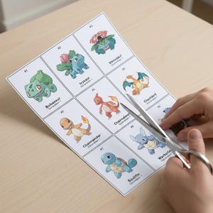 May include: A sheet of paper with nine different Pok&eacute;mon illustrations, including Bulbasaur, Ivysaur, Venusaur, Charmander, Charmeleon, Charizard, Squirtle, and Wartortle. Scissors are cutting out the images. The illustrations are in color and numbered.