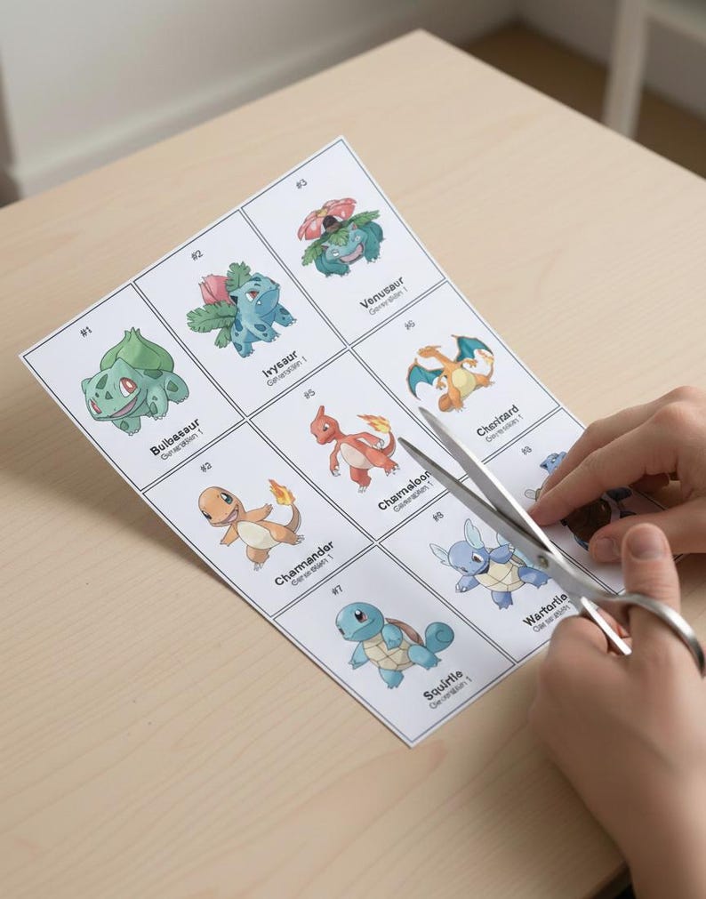 May include: A sheet of paper with nine different Pok&eacute;mon illustrations, including Bulbasaur, Ivysaur, Venusaur, Charmander, Charmeleon, Charizard, Squirtle, and Wartortle. Scissors are cutting out the images. The illustrations are in color and numbered.