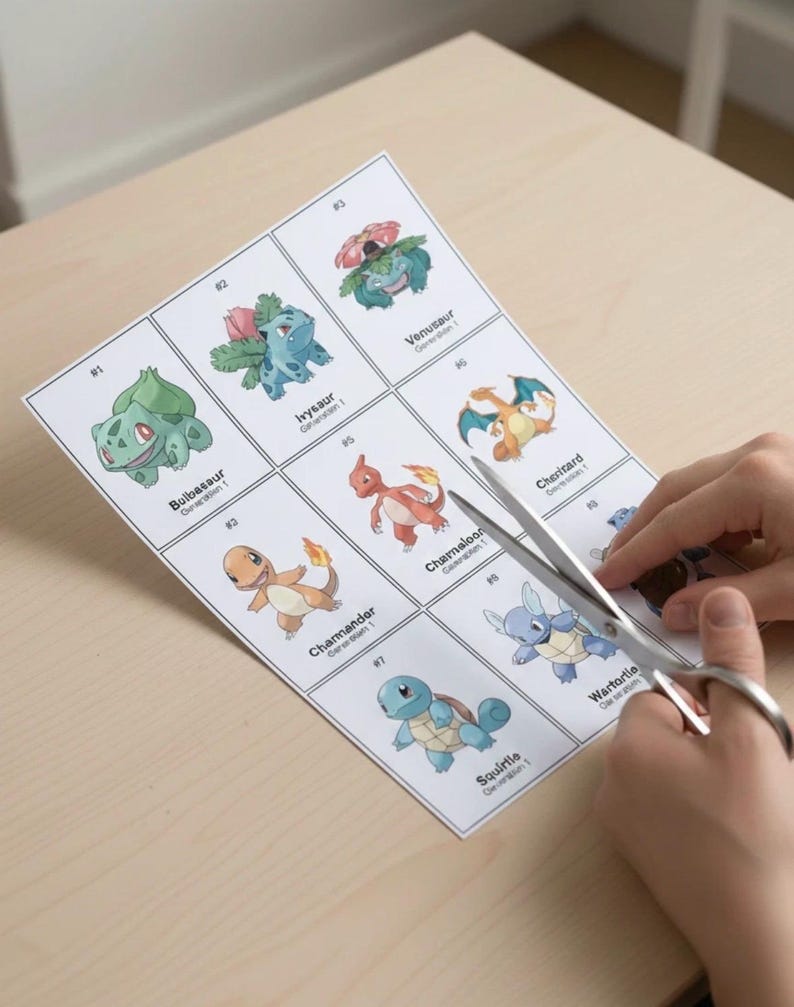 May include: A printed sheet of Pok&eacute;mon trading cards featuring Bulbasaur, Ivysaur, Venusaur, Charmander, Charmeleon, Charizard, Squirtle, and Wartortle. Scissors are cutting the sheet on a light wood surface.