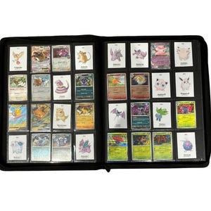 May include: A black binder filled with various Pok&eacute;mon trading cards. The cards are in protective sleeves and organized in rows. The cards feature colorful illustrations of different Pok&eacute;mon characters. The binder is open, displaying multiple pages of cards.