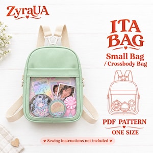 May include: A light green ita bag with beige straps and a clear front display window. The bag contains anime-style pins, a photo card, and a circular glitter charm. Text on the image includes ZyraUA, ITA BAG, Small Bag, Crossbody Bag, and PDF PATTERN.