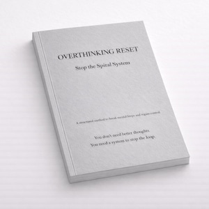 May include: A light gray book titled "OVERTHINKING RESET" with the subtitle "Stop the Spiral System." The book's cover includes the text "A structured method to break mental loops and regain control." and "You don't need better thoughts. You need a system to stop the loop."