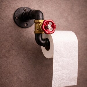 May include: A set of three ceramic mugs with a speckled, matte finish. The mugs are in shades of cream, light brown, and dark brown. Each mug has a simple, minimalist design and a rounded handle.