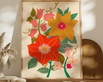 May include: A framed wall art print featuring a vibrant floral illustration with large red and yellow flowers, green leaves, and small pink blossoms on a cream background, displayed alongside a brown llama-patterned pillow and textured cushions.