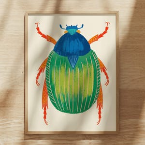 May include: A framed art print featuring a stylized illustration of a beetle with a vibrant blue head, a textured green body with vertical stripes, and bright orange legs, all set against a solid off-white background within a light wood frame.