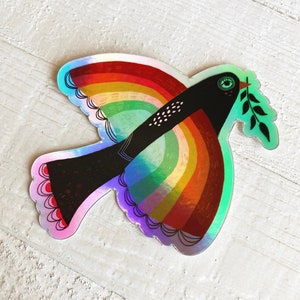 May include: A rainbow-colored peace dove with a green olive branch in its beak. The dove is black with white dots and has a green eye. The dove is flying with its wings spread out.