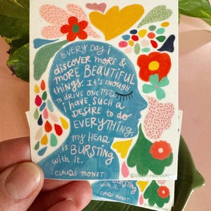 May include: A colorful illustration of a person's head with flowers and text that reads "EVERY Day i discover MORE & MORE BEAUTIFUL things. It's ENOUGH to drive ONE MAD i have SUCH a DESIRE to do EVERYTHING, My HEAD is BURSTING with it. - CLAUDE MONET"