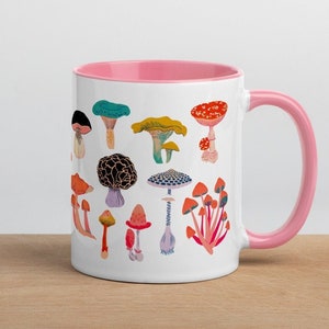 May include: White ceramic mug with a pink rim and handle. The mug features a colourful illustration of various mushrooms.