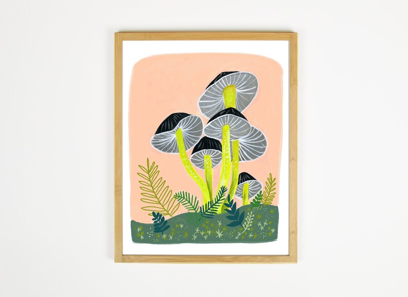 May include: A framed illustration of a cluster of gray and black mushrooms with yellow stems on a peach background. The mushrooms are surrounded by green foliage and white stars.
