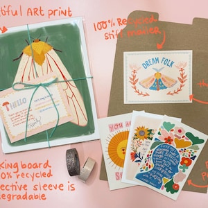 May include: A set of illustrated greeting cards featuring a moth, flowers, and inspirational text. The cards are packaged in a brown envelope with a 'Dream Folk' card inside. The set also includes free postcards.