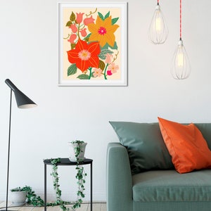 May include: A framed print of a floral illustration featuring orange, yellow, and pink flowers with green leaves on a cream background.