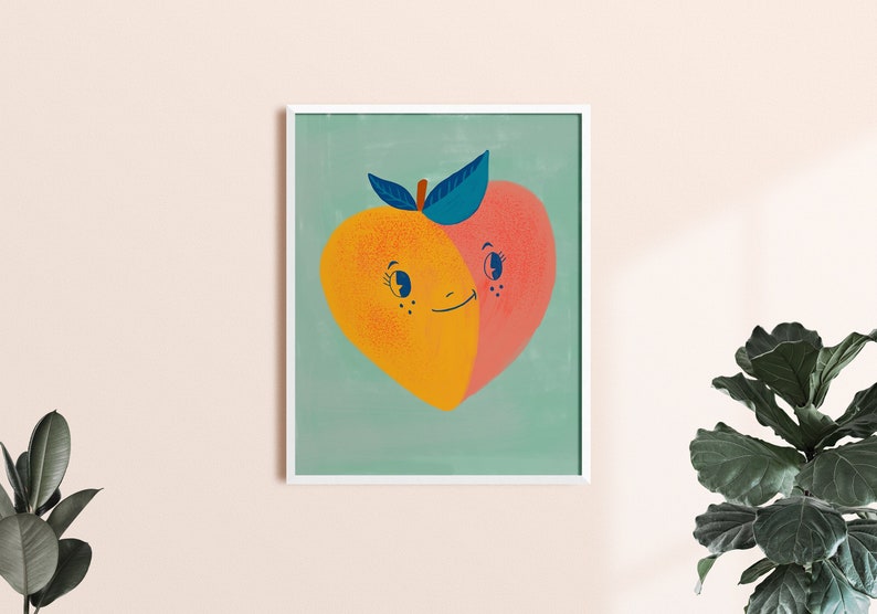 May include: A framed illustration of two peaches, one yellow and one pink, with smiling faces and a single green leaf on top. The peaches are on a light green background.