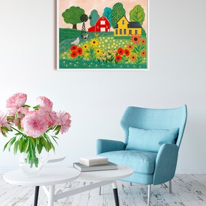 May include: A colorful painting of a red barn and a yellow house in a field of flowers. The painting is framed in white and hangs on a white wall.