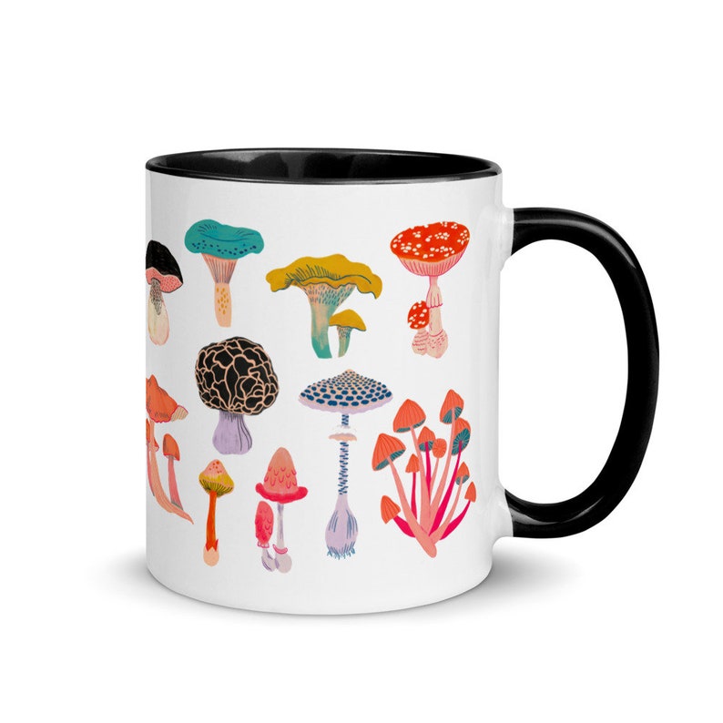 May include: White ceramic mug with a black rim and handle. The mug features a colourful illustration of various types of mushrooms.