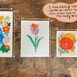 May include: Four rectangular art prints of varying sizes. The largest print, 13 by 17.5 inches, features a blue silhouette profile with text. The 11 by 14 inch print shows a tulip. The 8 by 10 inch print displays poppies. The 5 by 7 inch print shows flowers.