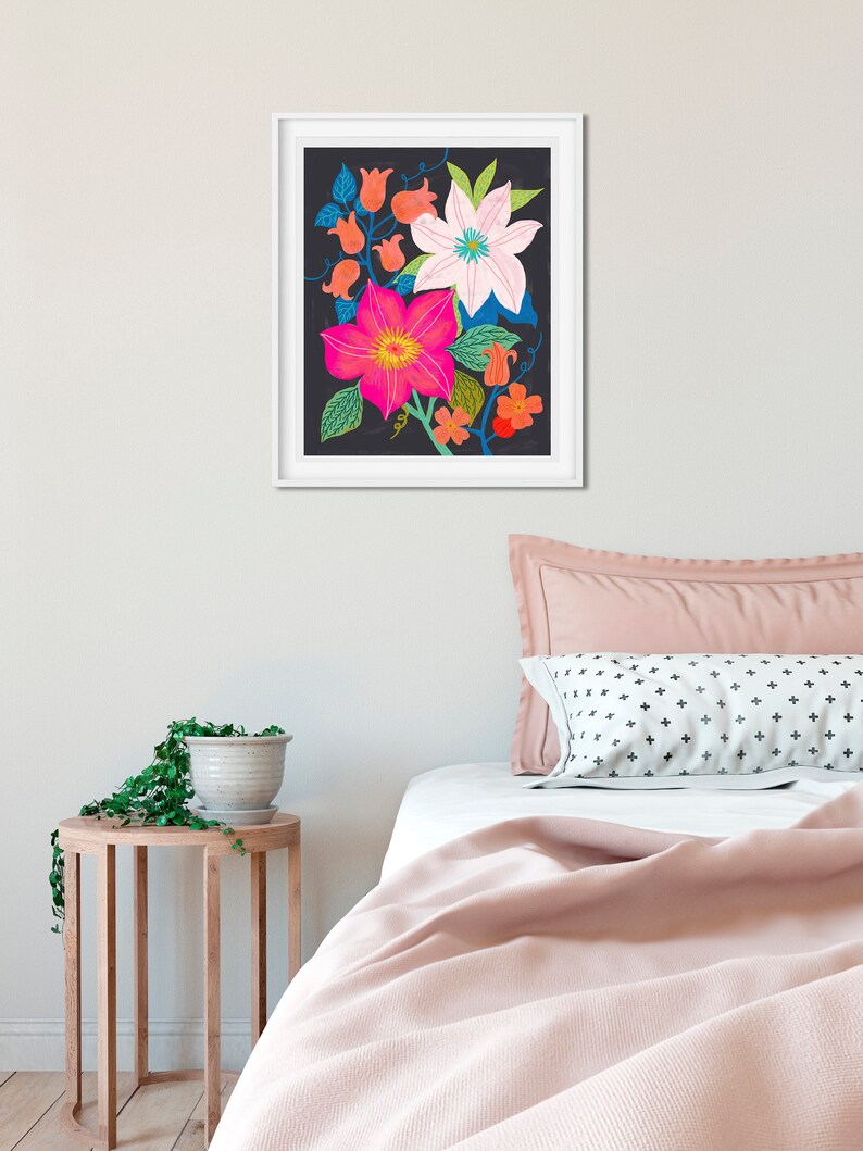 May include: A framed print of a floral illustration featuring pink, white, and orange flowers on a black background.