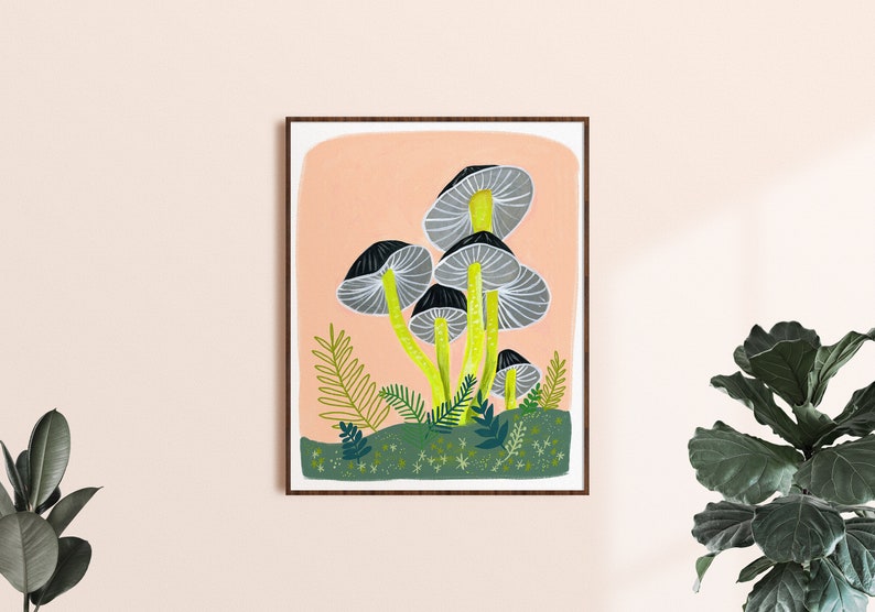 May include: A framed illustration of a cluster of gray mushrooms with yellow stems on a peach background. The mushrooms are surrounded by green foliage and white stars.