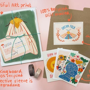May include: A set of illustrated greeting cards featuring a moth, flowers, and inspirational text. The cards are packaged in a brown envelope with a 'Dream Folk' card inside. The set also includes free postcards.