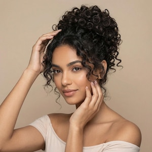 May include: A white ceramic mug with a black handle and the text "But First, Coffee" in a bold, black font. The mug is set against a blurred background, suggesting a cozy setting.