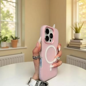 May include: A light pink phone case with a white circular design and a small white antenna-like detail at the top. The case has a camera cutout and a blue button on the side. The phone case is designed for a smartphone.