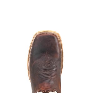 May include: A close-up shot of a brown leather cowboy boot. The boot has a square toe, decorative stitching, and a light-coloured sole. The leather has a distressed look, giving it a rustic feel. The boot is set against a white background.
