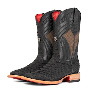 May include: Black cowboy boots with a textured, scaly design on the lower section and smooth leather on the upper shaft. The boots feature a red interior, brown mesh accents, and a square toe with a light brown sole and orange trim.