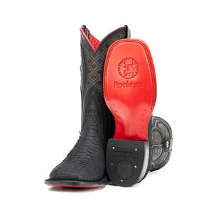 May include: Black cowboy boots with a textured pattern and red accents. The boots have a square toe and a red sole. The inside of the boot is red with a diamond pattern. The brand name "Rockem" is visible.