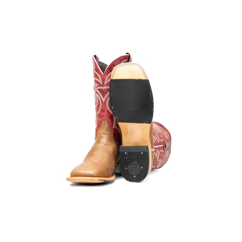 May include: A pair of cowboy boots. One boot is tan with a square toe, and the other is red with a decorative pattern. The sole of one boot is visible, showing a black rubber sole.
