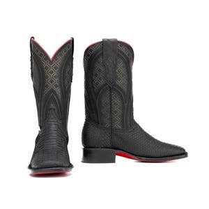 May include: Black cowboy boots with a textured pattern and red soles. The boots have a square toe and a tall shaft with decorative stitching. The interior trim is red. A stylish western boot.